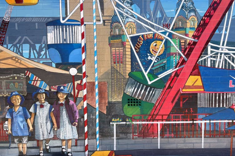 Colourful school mural with ferris wheel and 3 school students in bottom left corner